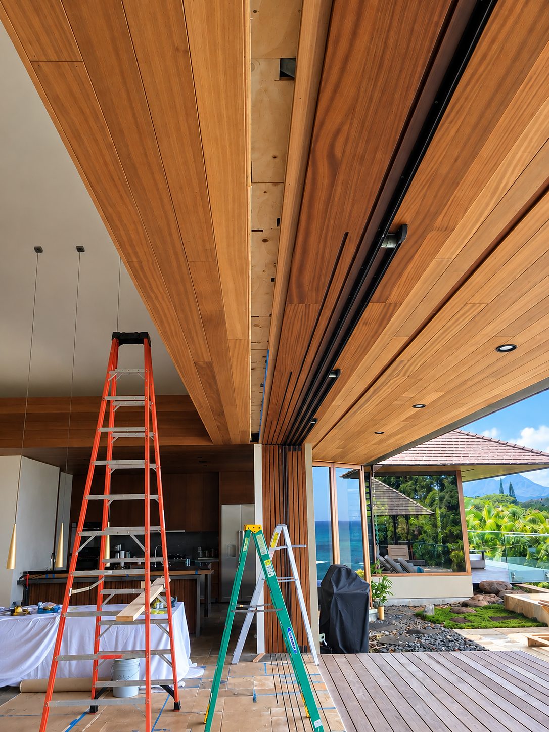 Recessed box for the blinds in the teak ceiling, ladders below and the lanai beyond